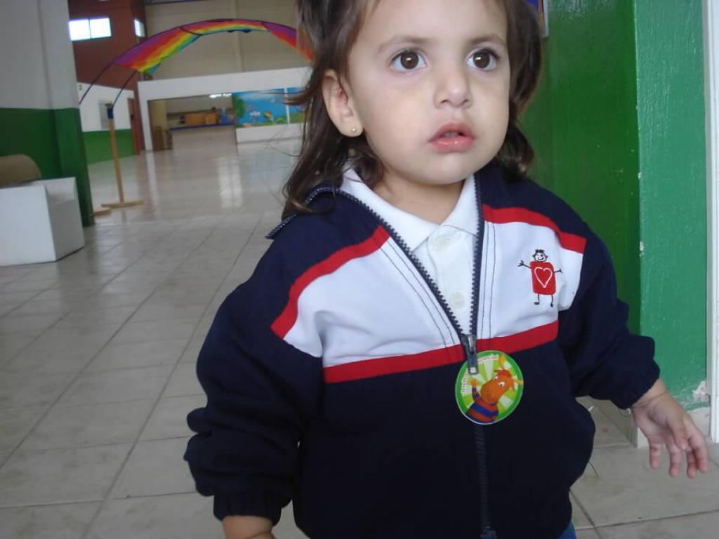 Child wearing a school uniform jacket